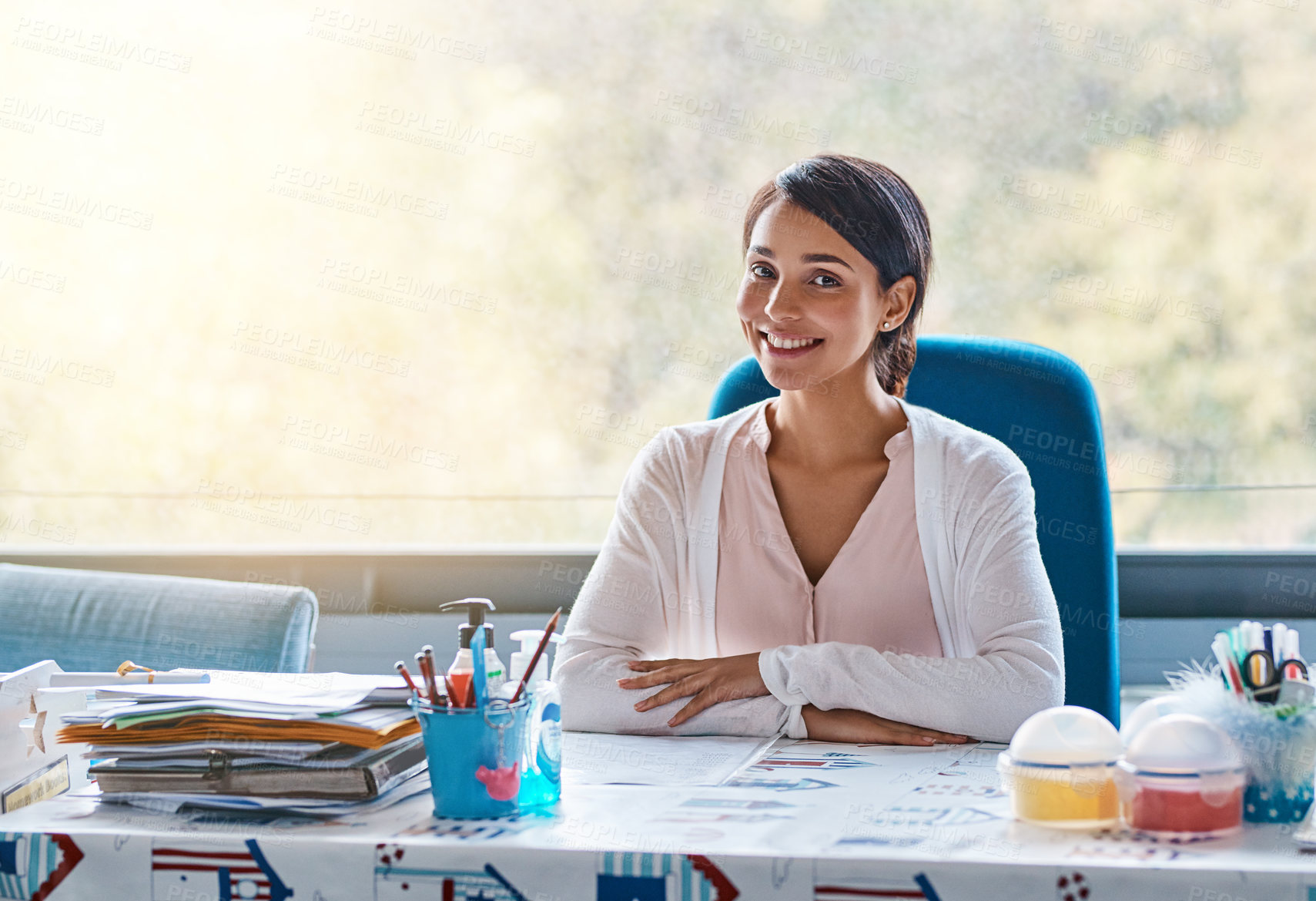 Buy stock photo Woman, teacher and smile on desk in classroom with pride for education and lesson in Spain. Female person, employee and happy or satisfied on portrait with career growth and development in school