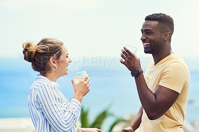 Buy stock photo Shot of a young couple enjoying drinks together while relaxing outdoors on holiday