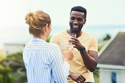 Buy stock photo Couple, balcony and alcohol to relax or talking in outdoor, bonding and together for love or laughing. People, terrace and drink on holiday or vacation, joke and trees or juice for peace and calm