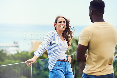 Buy stock photo Shot of a young couple spending some quality time together outdoors on holiday