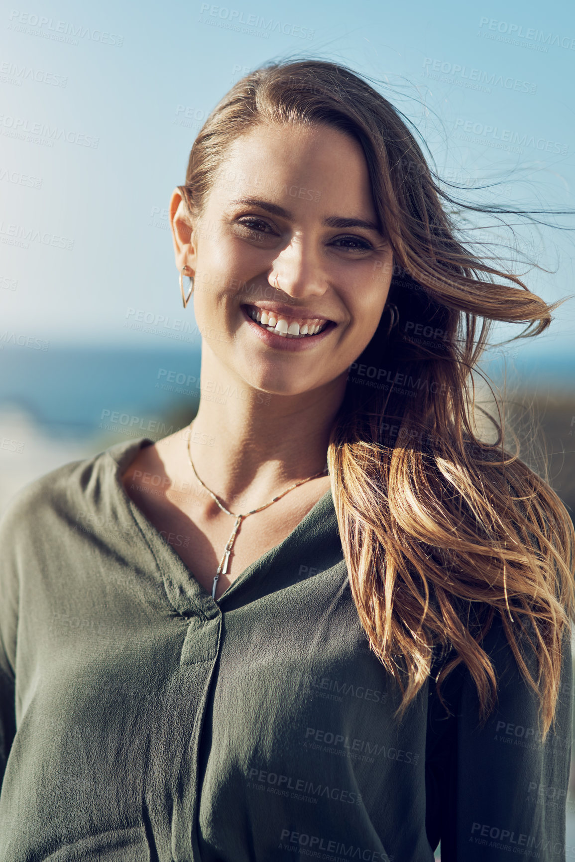 Buy stock photo Portrait of an attractive young woman relaxing outdoors