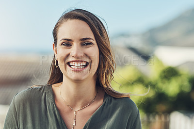 Buy stock photo Portrait of a cheerful young woman relaxing outdoors