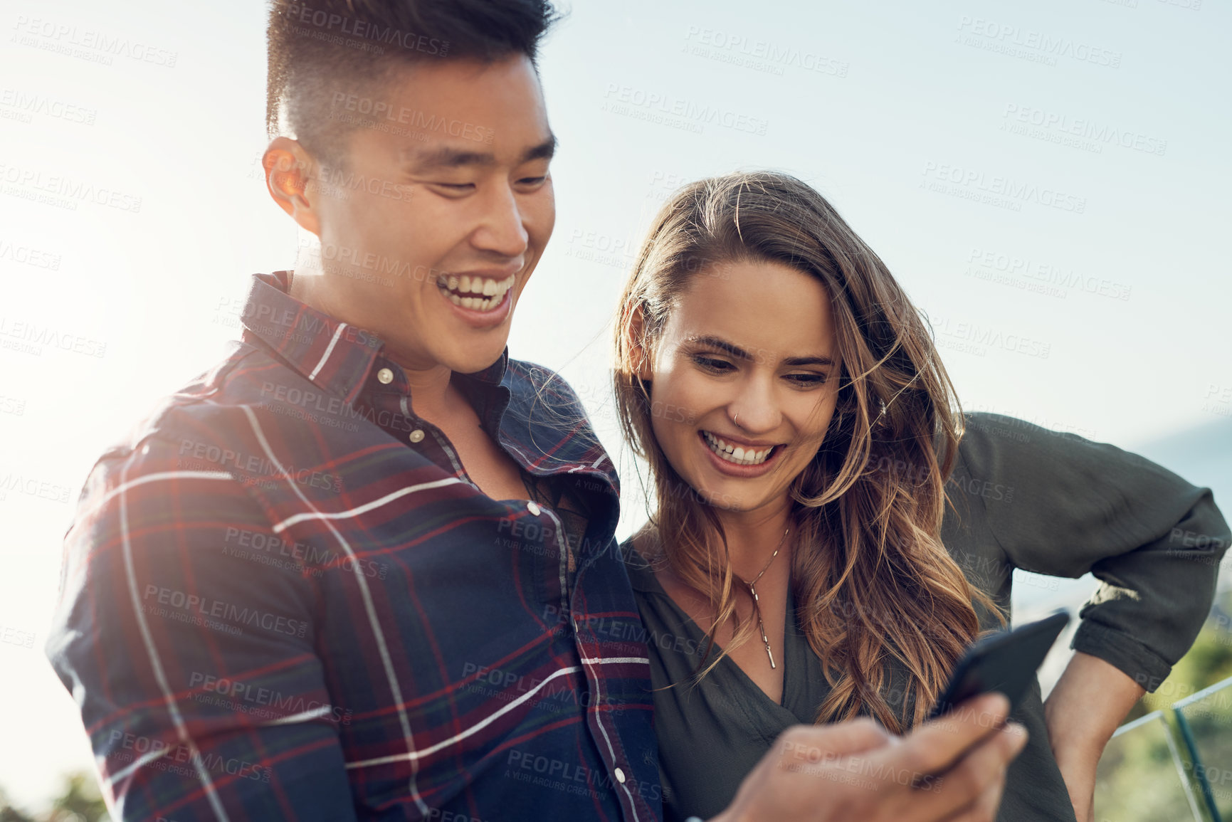 Buy stock photo Happy couple, laughing and balcony with phone for funny joke, social media, online post in nature. Young man and woman with smile on mobile smartphone for comedy, humor or outdoor chatting on app