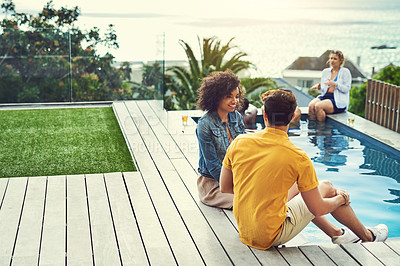 Buy stock photo Shot of a group of friends having drinks and enjoying themselves poolside on holiday