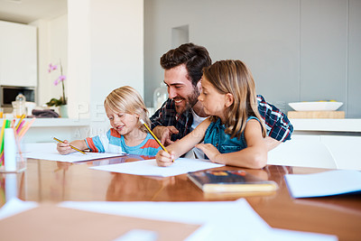 Buy stock photo Shot of a young father helping his two small children with their homework at home