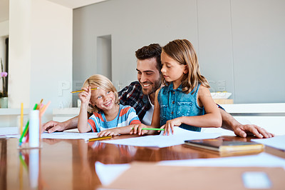 Buy stock photo Shot of a young father helping his two small children with their homework at home