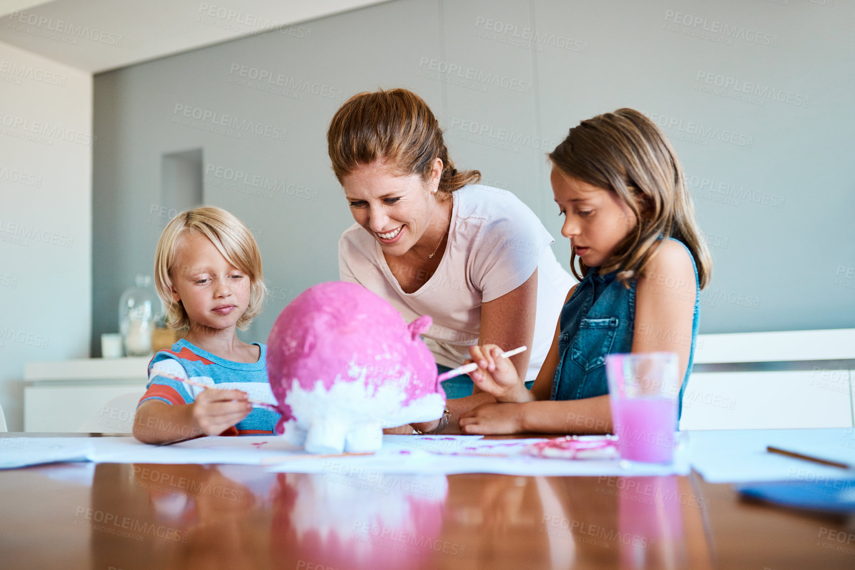 Buy stock photo Mom, children and art project for school in home, painting study and together for creativity. Mama, support kids and kindergarten assignment on table, education and teaching knowledge on color play