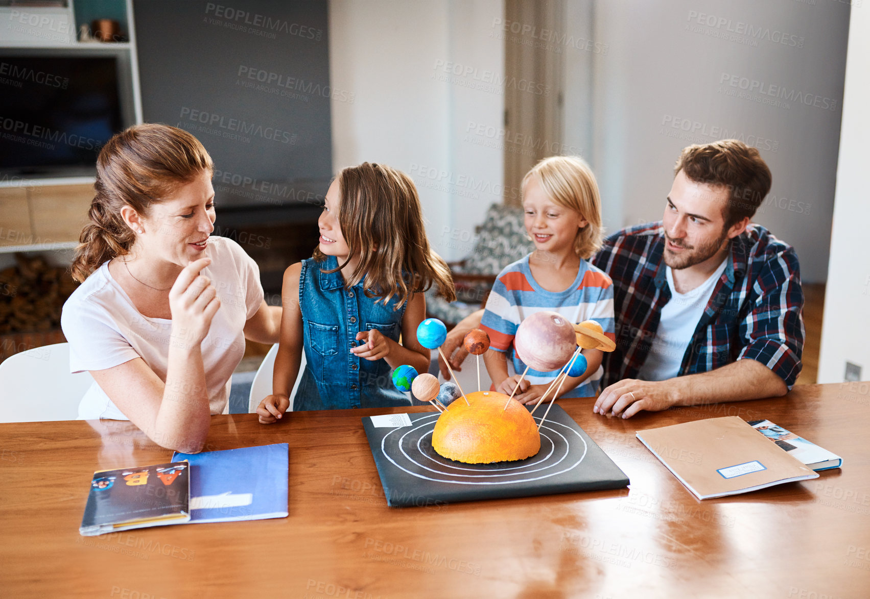 Buy stock photo Happy, family and planet project at house for solar system education, universe formation and creative design. Smile, parents and children with science model for learning galaxy, earth art and support