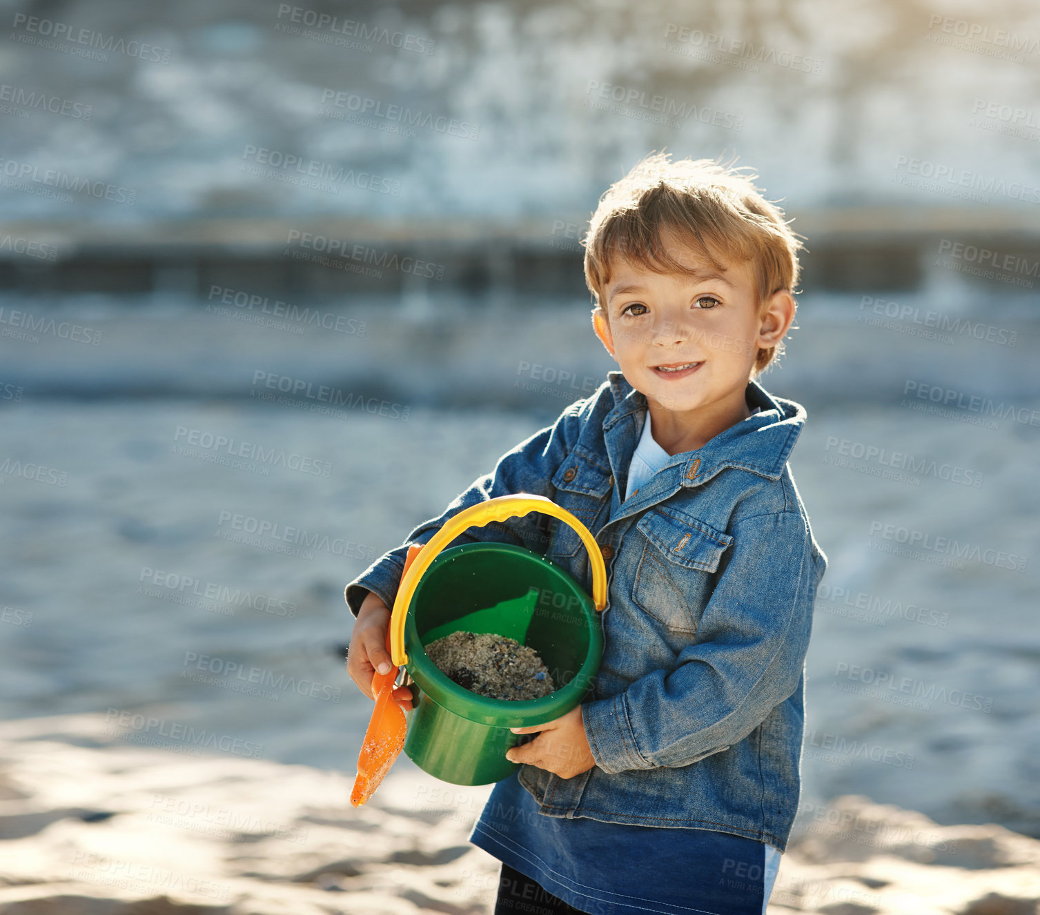 Buy stock photo Portrait of an adorable little boy playing at the beach