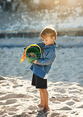 Buy stock photo Shot of an adorable little boy playing at the beach