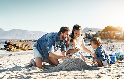 Buy stock photo Sandcastle fun, parents and children at the beach with bonding, love and support. Baby, mom and dad together with kids playing in the sun with happiness and smile by the ocean and sea with family