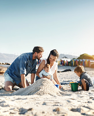 Buy stock photo Sandcastle, holiday and children at the beach with family, love and support. Baby, mom and dad together with kids playing in the sun with happiness and smile by the ocean and mockup with bonding