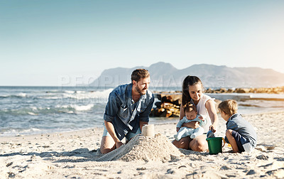 Buy stock photo Sandcastle, happy summer and children at the beach with bonding, love and support. Baby, mom and dad together with kids playing in the sun with mockup space and smile by the ocean and sea with family