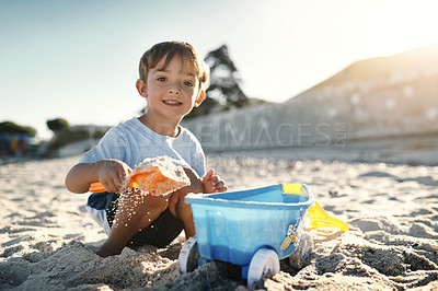 Buy stock photo Shot of an adorable little boy having fun at the beach