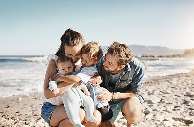 Buy stock photo Shot of a happy family bonding at the beach