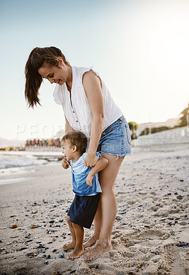 Buy stock photo Shot of a mother bonding with her little son at the beach