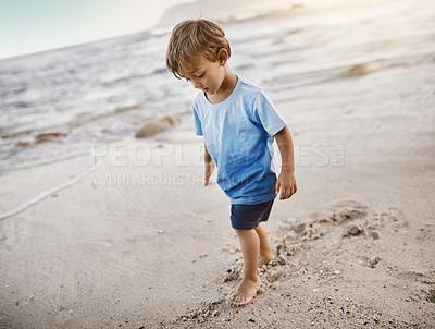 Buy stock photo Shot of an adorable little boy at the beach