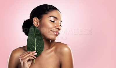 Buy stock photo Happy woman, leaf and natural beauty in studio, pink background and mockup for aesthetic cosmetics. Face, african model and skincare from plants, green leaves and sustainability of vegan dermatology