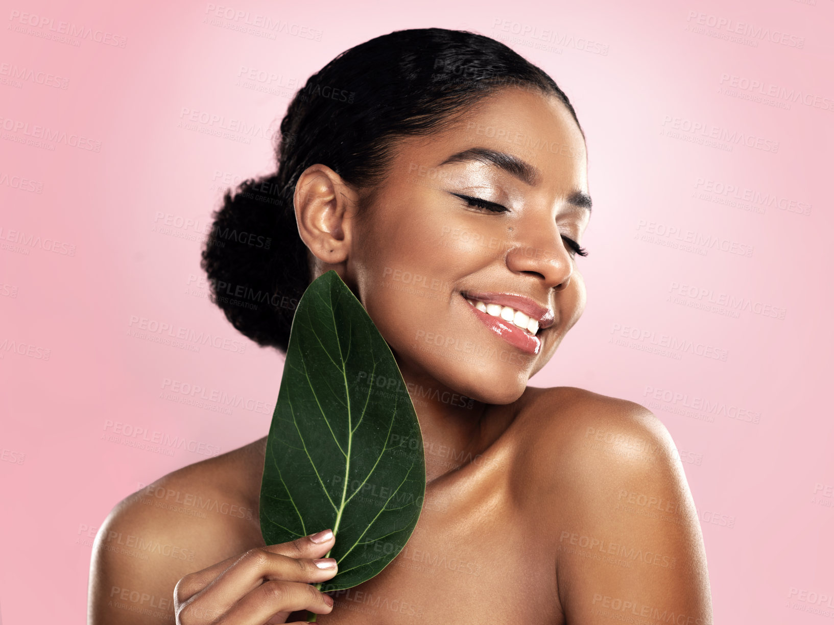 Buy stock photo Happy woman, green skincare and natural leaves in studio, pink background or eco friendly aesthetic cosmetics. Face, african model and beauty from plants, leaf and sustainability of vegan dermatology