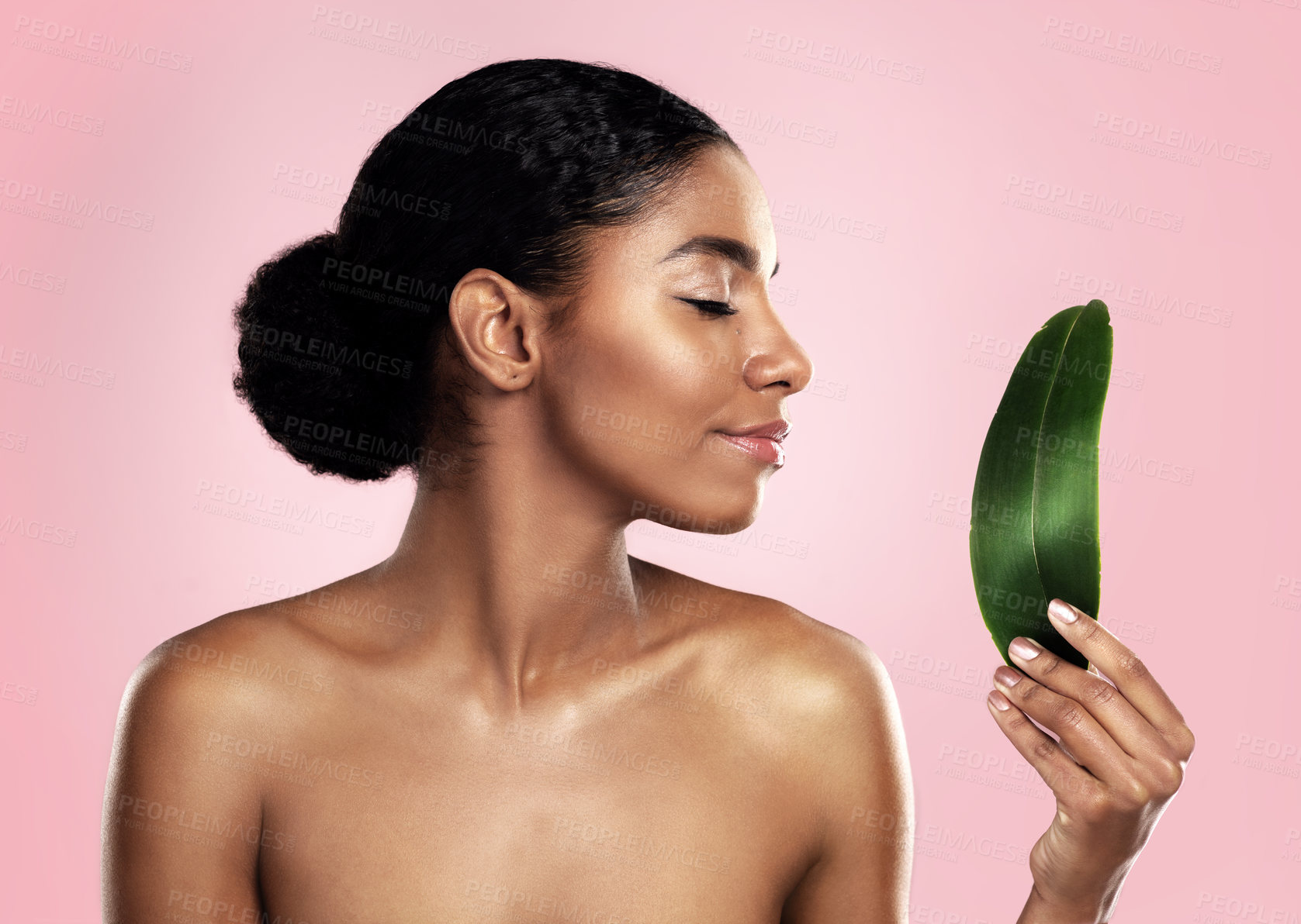 Buy stock photo Woman, leaf and natural beauty in studio, pink background and eco friendly sustainable cosmetics. Face, african model and skincare from plants, green leaves and sustainability of vegan dermatology 