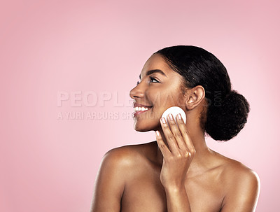 Buy stock photo Studio shot of a beautiful young woman cleaning her face with cotton wool