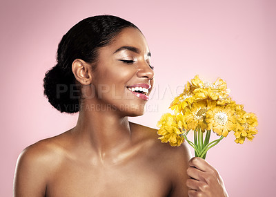 Buy stock photo Happy woman, yellow flowers and natural skincare in studio, pink background and eco friendly makeup cosmetics. African model, beauty and smile with daisy plants, happiness and glow of floral facial