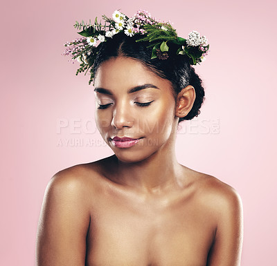 Buy stock photo Woman, flowers and crown for beauty in studio, pink background and natural skincare. African face, female model and floral headband of spring plants, sustainable cosmetics and eco friendly makeup 