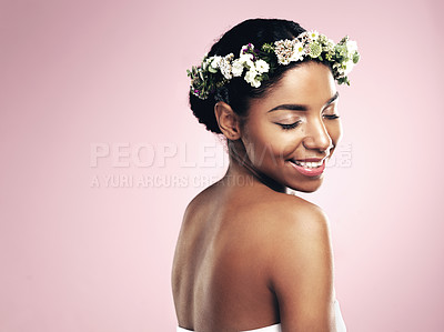 Buy stock photo Woman, crown and flowers in hair, pink background and studio for natural beauty, plants and mockup. Happy african model, skincare and floral wreath for sustainability, eco friendly cosmetics and glow