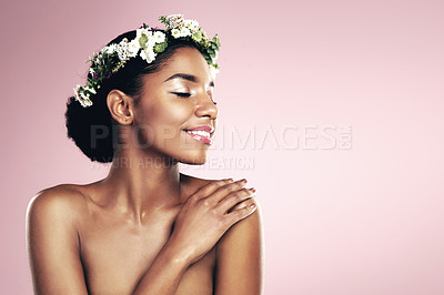 Buy stock photo Woman, flower crown and natural beauty in studio, pink background and aesthetic plants with mockup. Happy african model, skincare and floral wreath in hair for sustainable cosmetics, shine and glow