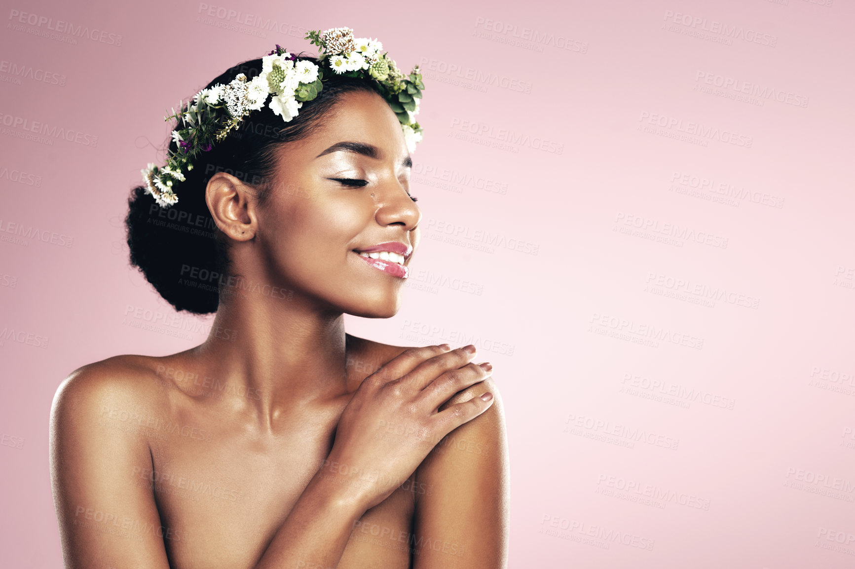 Buy stock photo Woman, flower crown and natural beauty in studio, pink background and aesthetic plants with mockup. Happy african model, skincare and floral wreath in hair for sustainable cosmetics, shine and glow
