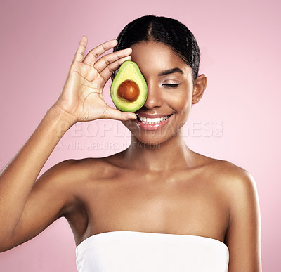 Buy stock photo Avocado, happy woman and healthy beauty in studio, pink background and aesthetic glow. African model, natural skincare and organic cosmetics for sustainability, vegan dermatology and facial nutrition