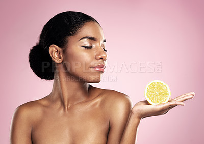 Buy stock photo Lemon, natural beauty and woman in studio, pink background and mockup of nutrition. African model, healthy skincare and citrus fruit of sustainable cosmetics, vegan dermatology and vitamin c benefits