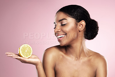 Buy stock photo Lemon, healthy beauty and happy woman in studio mockup, pink background and smile for vitamin c benefits. African model, citrus fruits and natural skincare for cosmetics, vegan dermatology and detox