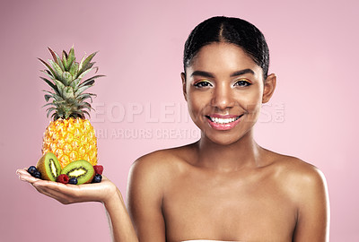 Buy stock photo Black woman, studio portrait and fruit in hand for beauty with tropical food, makeup and diet with vitamins. African model girl, nutrition and pink background with health, vegan cosmetics and glow