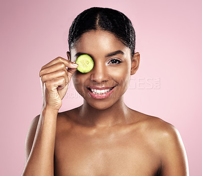 Buy stock photo Skincare, cucumber and portrait of black woman in studio for facial routine, organic fruit or treatment on pink background. Dermatology, hand and model for glowing skin, vitamin c or collagen benefit