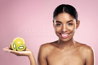 Buy stock photo Black woman, studio portrait and fruit for makeup with tropical food, clean beauty and vitamin c. African model girl, lemon and kiwi by pink background for vegan cosmetics, nutrition and skin glow
