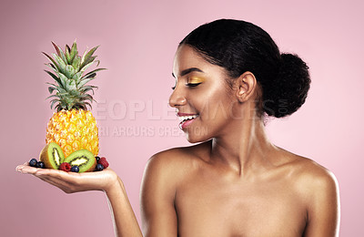 Buy stock photo Black woman, studio and beauty with fruit in hand for makeup, tropical food and clean diet with vitamin c. African model girl, nutrition and pink background for health, vegan cosmetics and skin glow