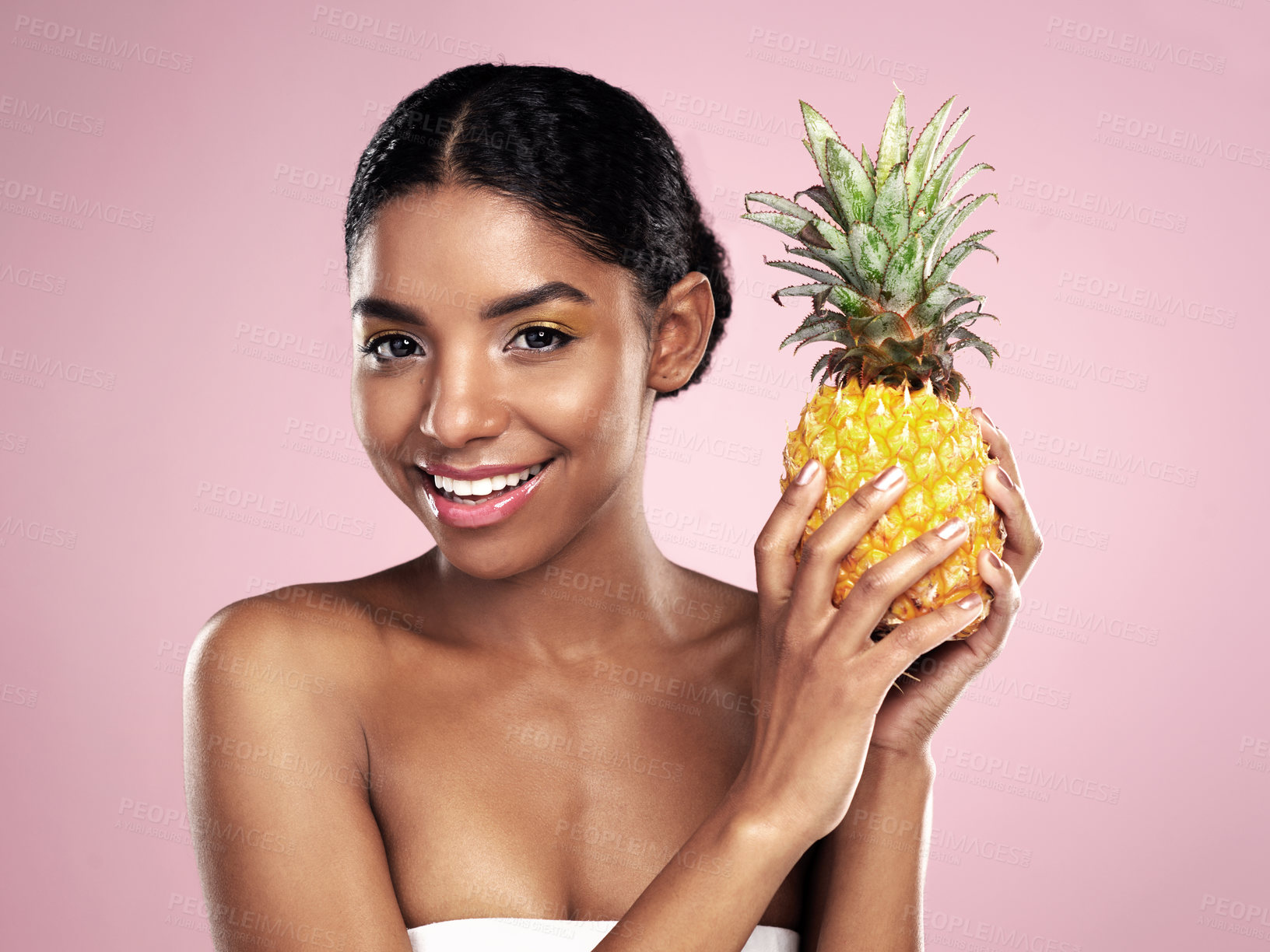 Buy stock photo Shot of a beautiful young woman holding up a pineapple against a pink background