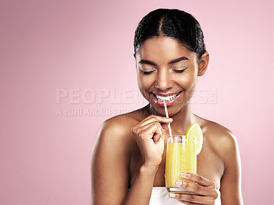 Buy stock photo Happy woman drink glass of orange juice in studio, pink background and mockup for healthy skincare. African model, fruit cocktail and smoothie for nutrition benefits, natural beauty or vitamin c diet