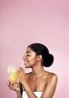 Buy stock photo Woman, healthy orange juice and smile in studio, pink background and mockup for vitamin c benefits. Happy african model, citrus smoothie and fruits for vegan nutrition, diet drink and natural beauty