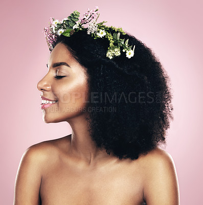 Buy stock photo Happy woman, face and flower crown for beauty in studio, pink background and natural skincare. Smile, african model and plants for floral wreath, spring cosmetics and dermatology of afro hair care