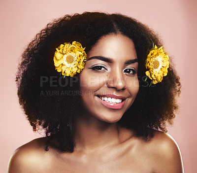Buy stock photo Portrait of happy woman, hair care and face with yellow flowers, natural beauty or pink background in studio. African model, skincare and daisy plants in afro for sustainable cosmetics, smile or glow