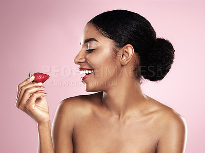 Buy stock photo Smile, profile and black woman with strawberry for nutrition, health and healthy diet isolated on pink background. Skin, gen z girl with fruit for food, wellness and happy on studio backdrop