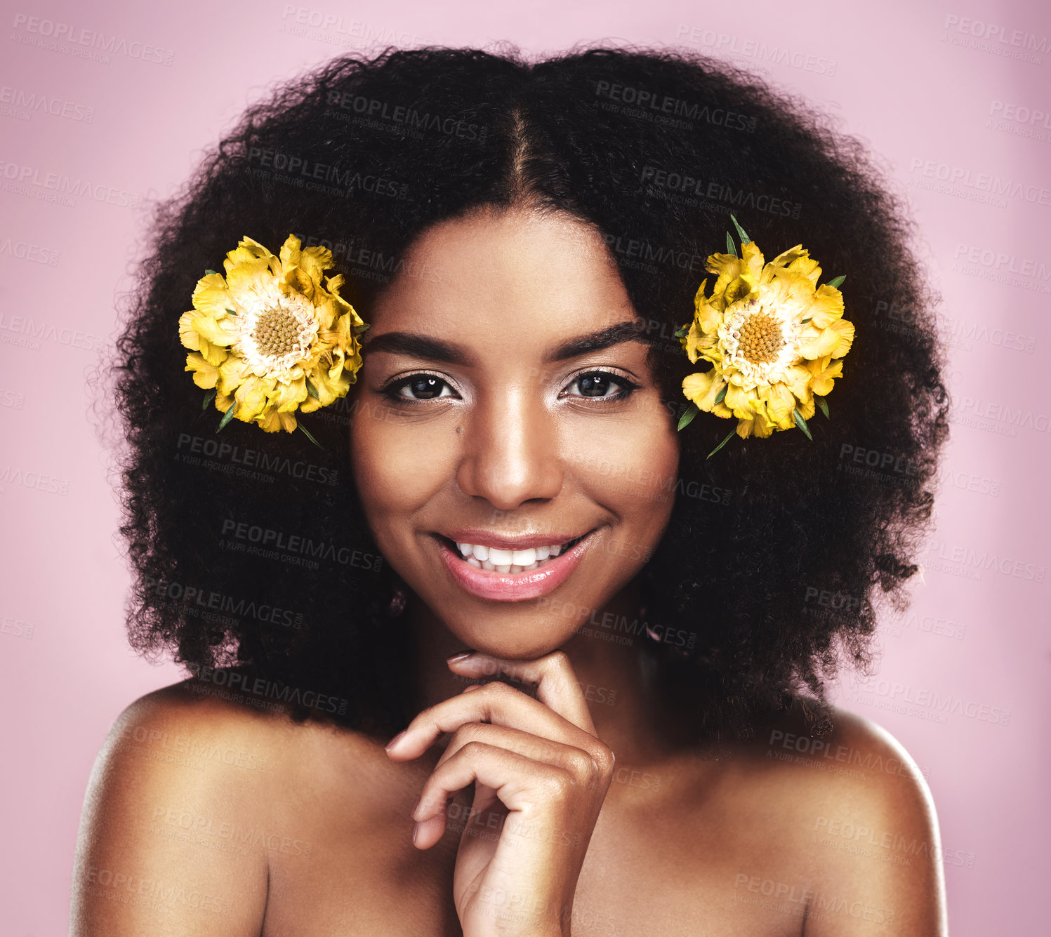 Buy stock photo Portrait, happy woman and hair care with yellow flowers in studio, pink background or natural beauty. Face of african model, skincare and daisy plants in afro for sustainable cosmetics, smile or glow