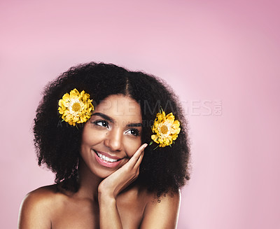 Buy stock photo Happy woman, thinking and flowers in hair in studio, pink background and mockup for aesthetic cosmetics. Face, african model and thought with floral plants, afro and beauty ideas for natural skincare