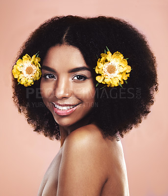 Buy stock photo Black woman, smile and portrait with flowers for natural beauty, fashion and afro haircare in studio. Female person, confident and skin care on brown background with glow, growth or organic treatment