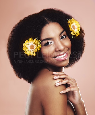 Buy stock photo African woman, portrait and flowers in studio for beauty, happiness and cosmetic on backdrop. Gen z female, plants and eco friendly salon treatment for sustainability and vegan haircare with glow