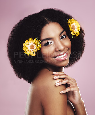 Buy stock photo Portrait, African woman and flowers in studio for beauty, wellness and cosmetic on pink backdrop. Gen z female, plants and eco friendly salon treatment for sustainability and vegan haircare with glow