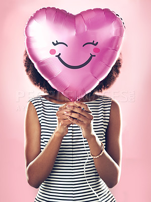 Buy stock photo Girl, studio and heart shape ballon with smile for celebration, love and romance. Female person, anniversary and valentines day gift by pink background for surprise, present and announcement