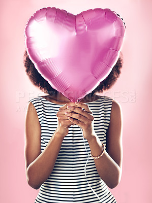 Buy stock photo Woman cover face with heart balloon in studio, pink background and celebrate surprise birthday party. Female model hide with helium, gift and present for love, valentines day and secret celebration